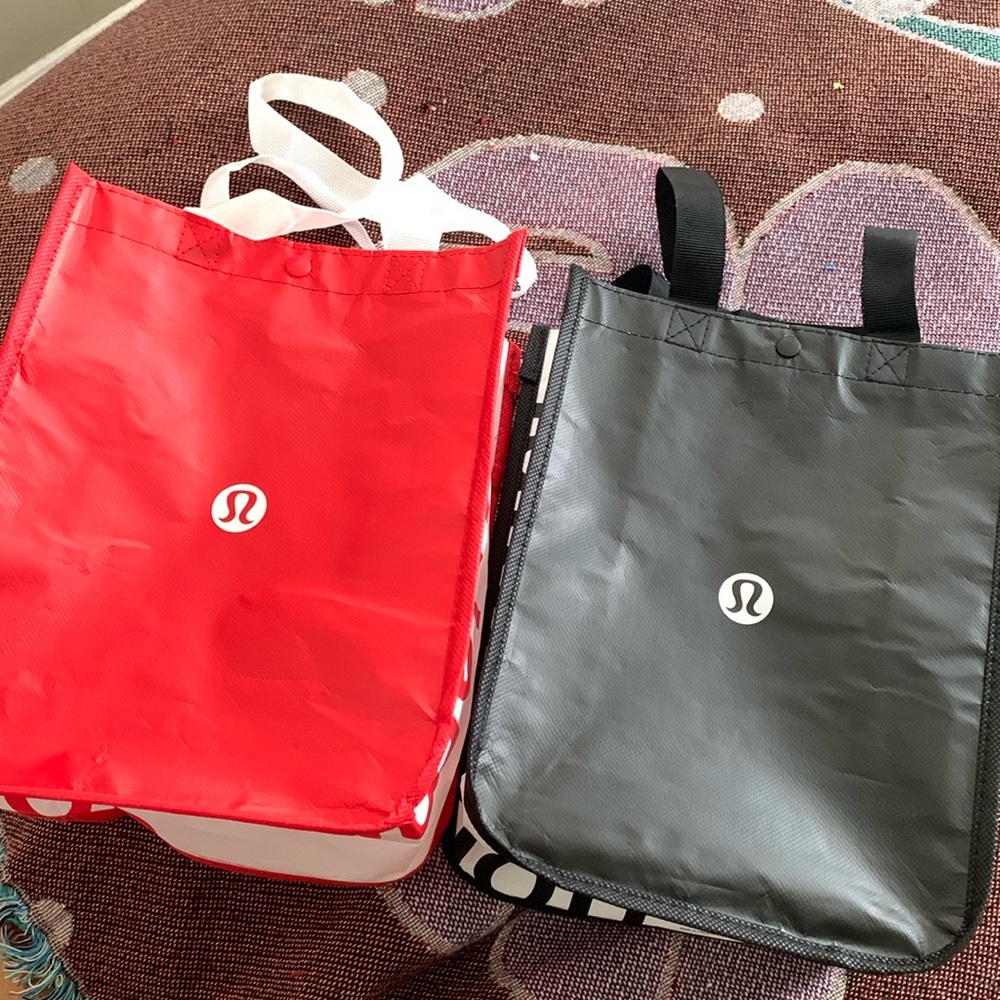 Two small Lululemon reusable shopping bags, red, black